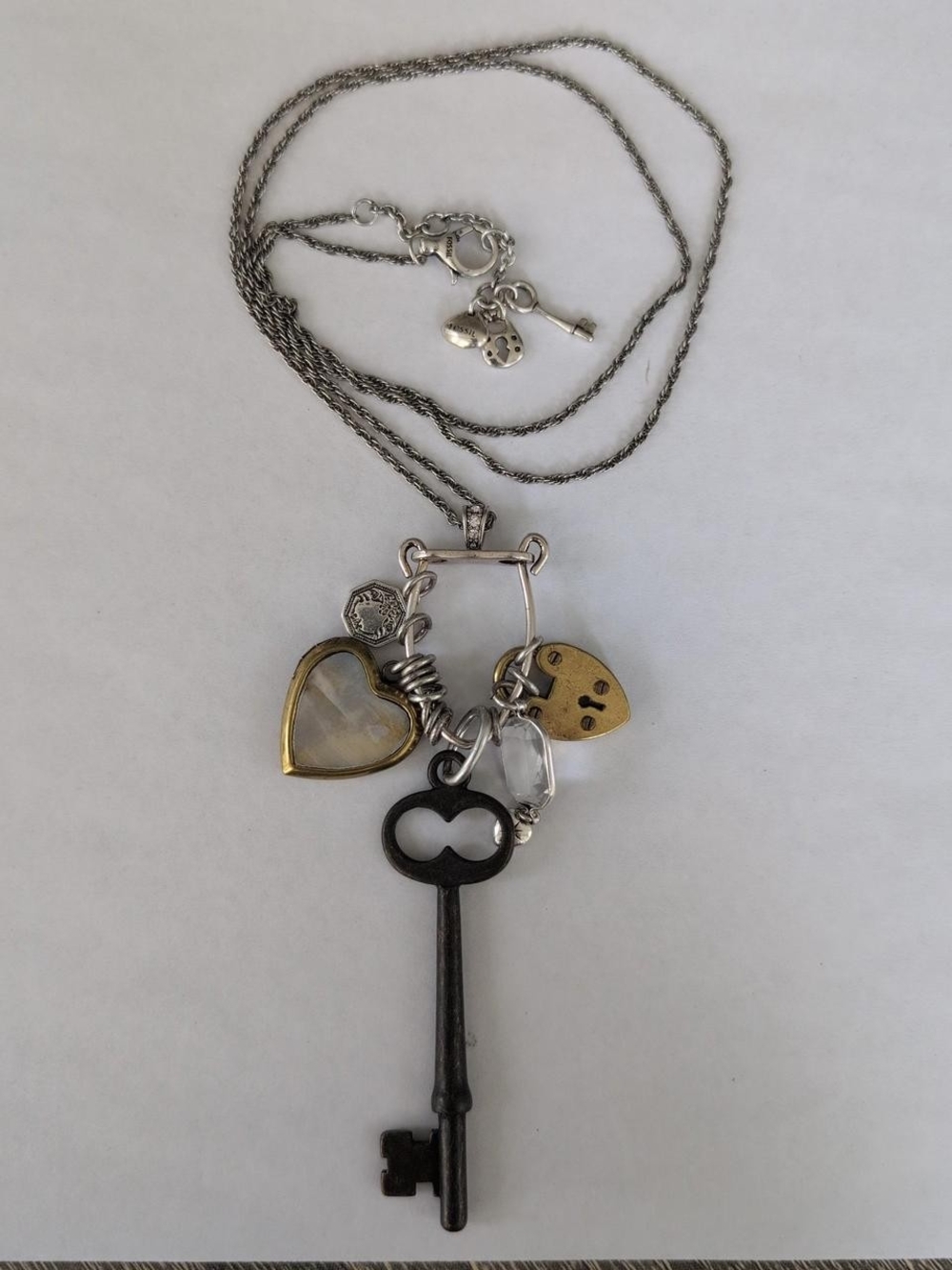 Fossil silver key necklace with rhinestone charms. adjustable size 26-28".